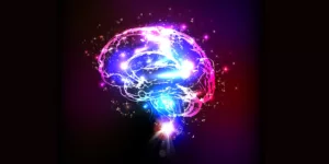 "Zdjęcie przedstawiające mózg z rozbłyskiem światła symbolizującym aktywność umysłu w kontekście artykułu o ludzkim umyśle, podświadomości, świadomości, inteligencji emocjonalnej i hipnozie."